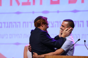 MK Yehuda Glick hugging EMT Kabaha Muawhiya during the ceremony at the knesset (Photo Credit: Aharon Crown - United Hatzalah)