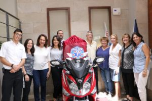 Members of the Jewish Federation of South Palm Beach Florida stand next to the ambucycle that they donated