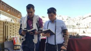 Srulie Beer with his Father Eli putting on Tefillin for the first time