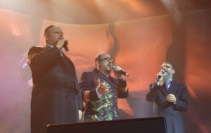 Avraham Fried, Chazzan Helfgot, and Lipa Schmeltzer sing in tandem during the concert