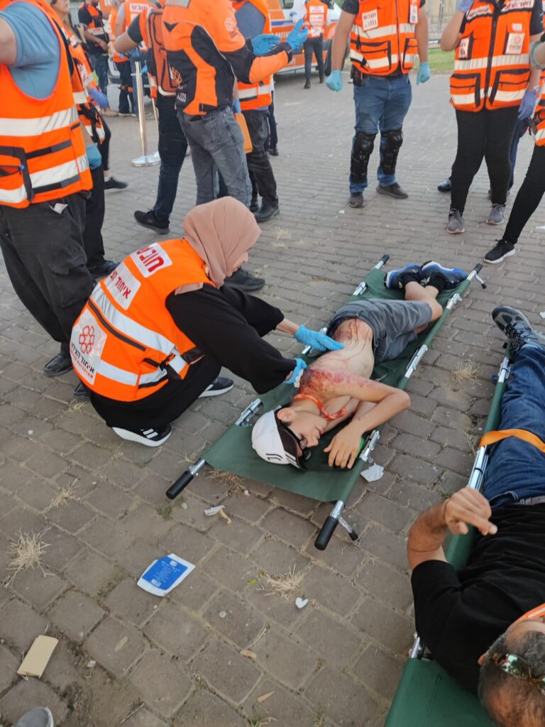 A Muslim EMT treats a patient for simulated injuries during the drill 768x1024 2