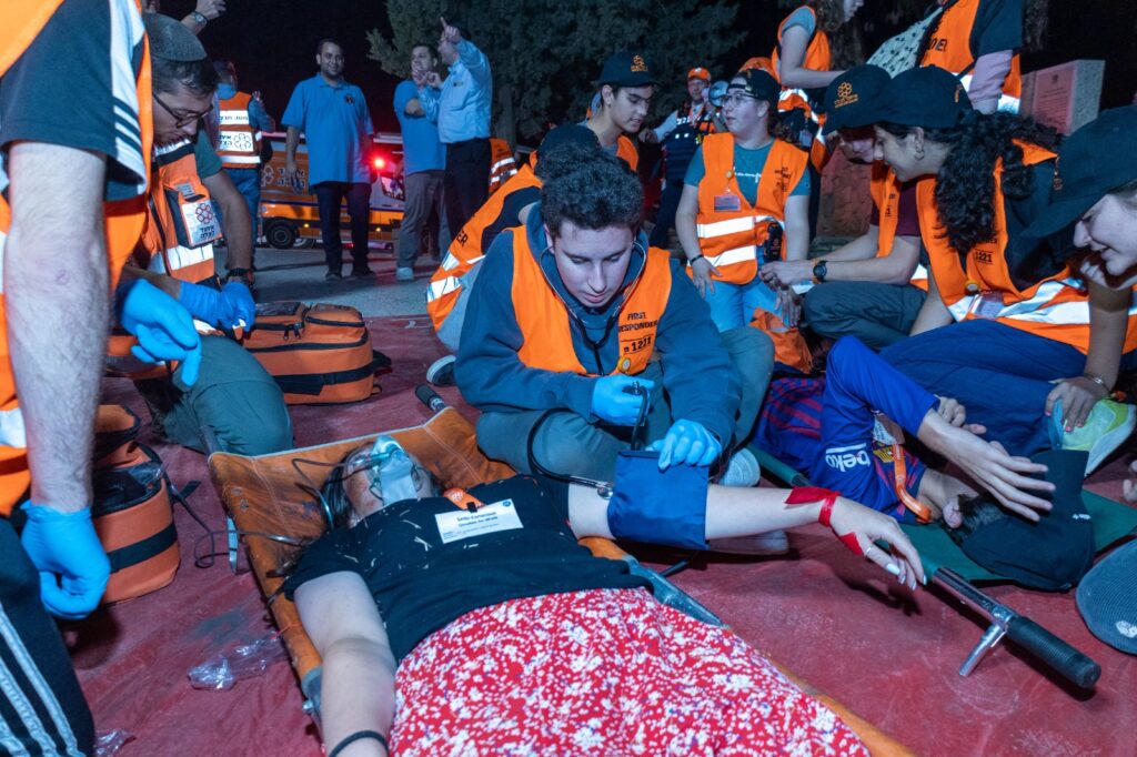 An NCSY Hatzalah rescue participant taking a simulated patients blood pressure during the trainign drill 1024x682 2