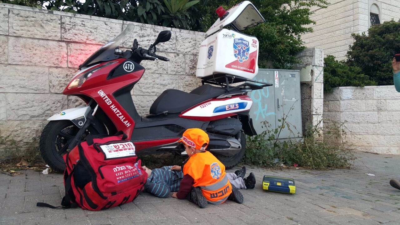 A young boy dressing up as a United Hatzalah EMT for Purim