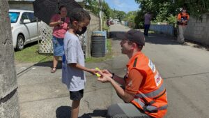 Avishai handing a candy to a young boy in Anasco Puerto Rico 1 300x169 1