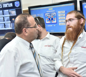 Ayoob Kara with a United Hatzalah command center operator