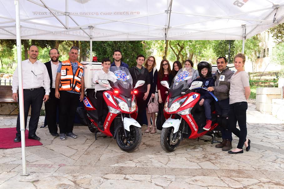 Ariela and her family together with Staff members and volunteer ambucycle drivers of United Hatzalah