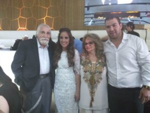 Sara Lee and Yoni take a picture with their Sarah's grandfather during the wedding. 