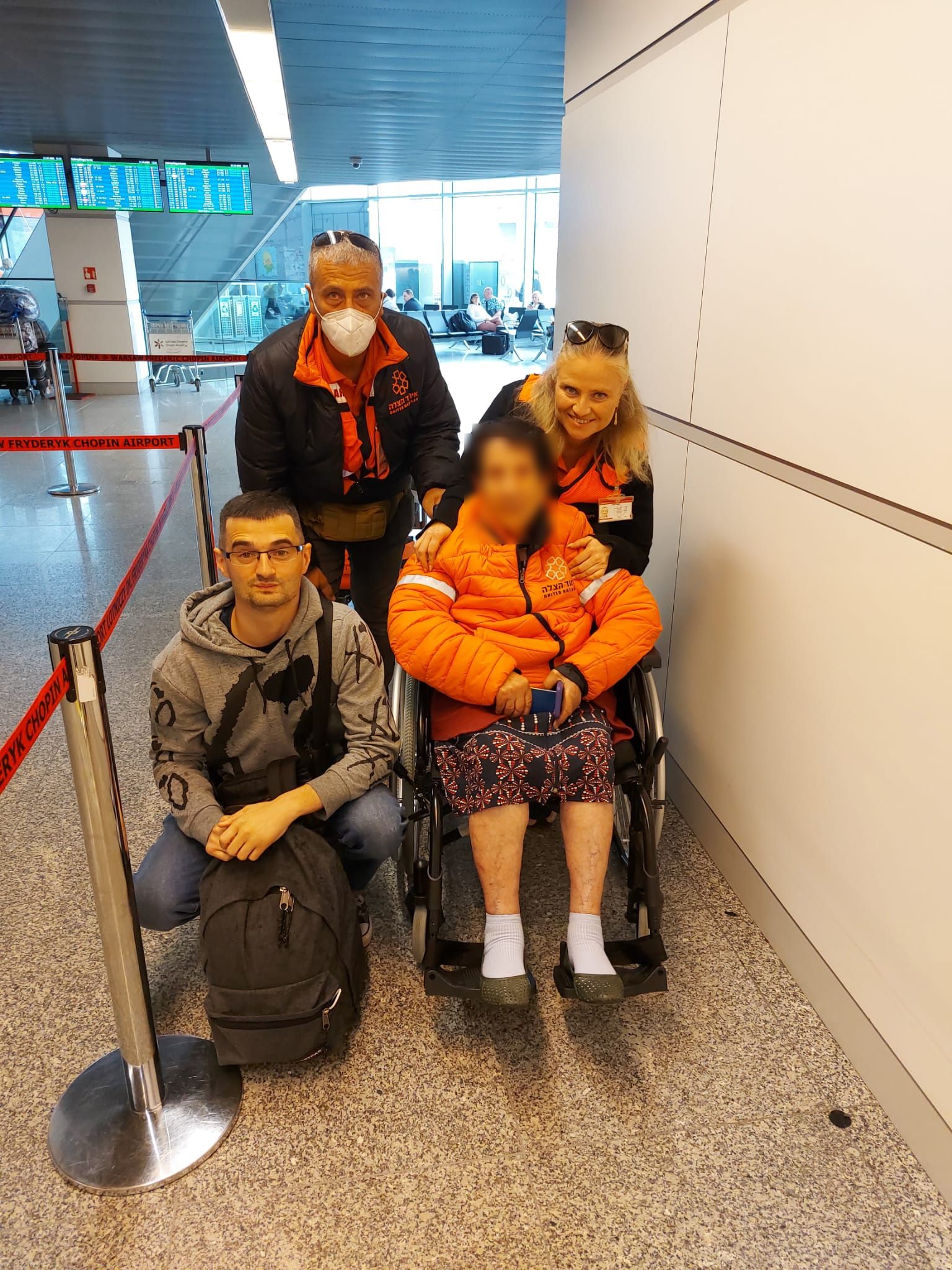 Donia and her grandson being accompanied by Khaled and Vicki before boarding the plane in Warsaw 1