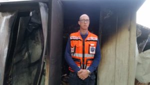 Doron standing in his back yard after the fire