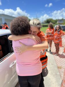 Dr. Camilla Farkash Lavan hugging a woman in Puerto Rico after working with her on the ground 225x300 1
