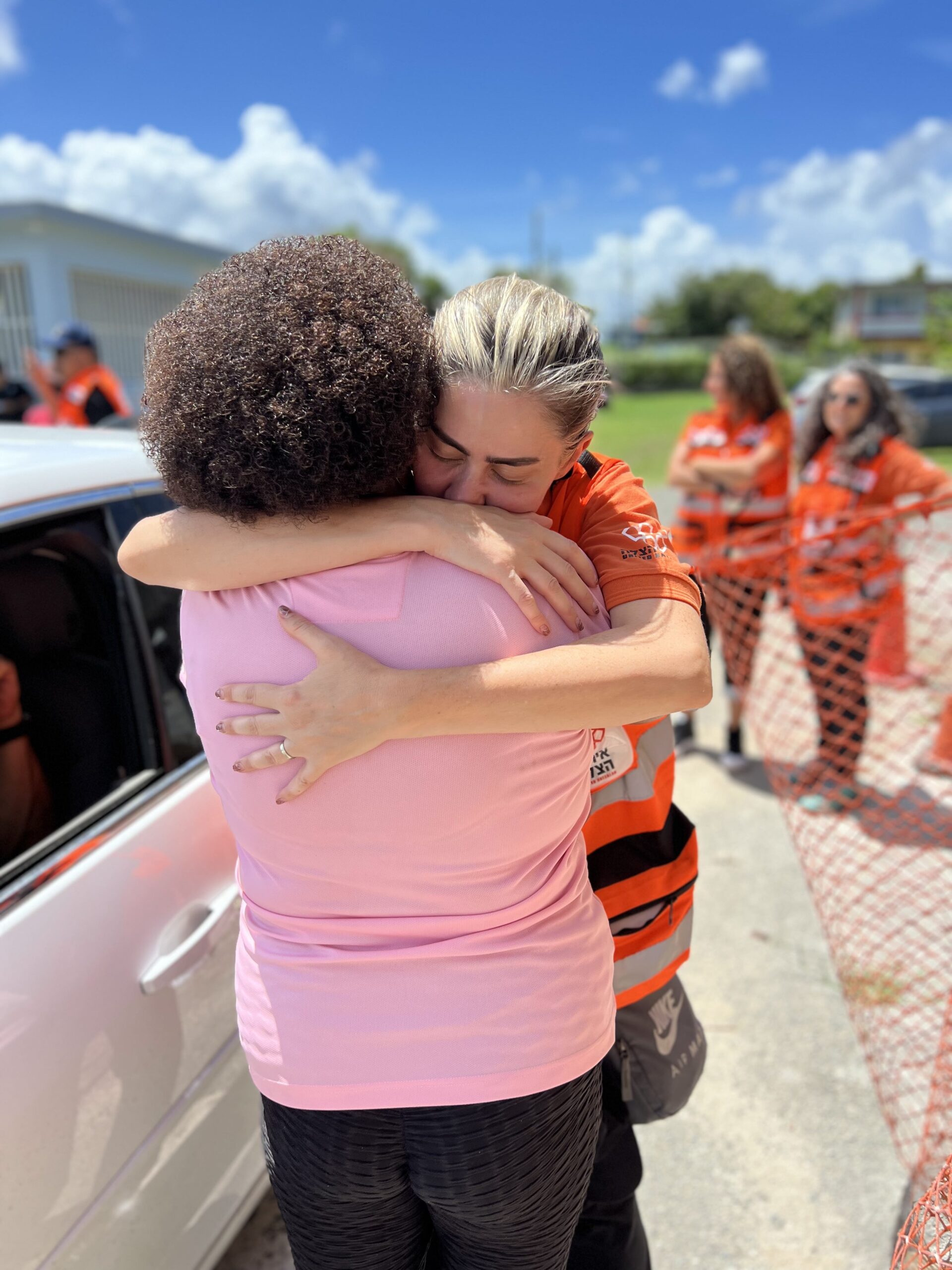 Dr. Camilla Farkash Lavan hugging a woman in Puerto Rico after working with her on the ground scaled 1