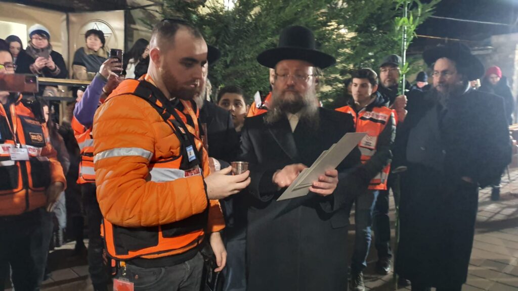 EMT Yechiel Gurfein reciting one of the blessings during the double wedding of refugees in Kishinev 1024x576 2