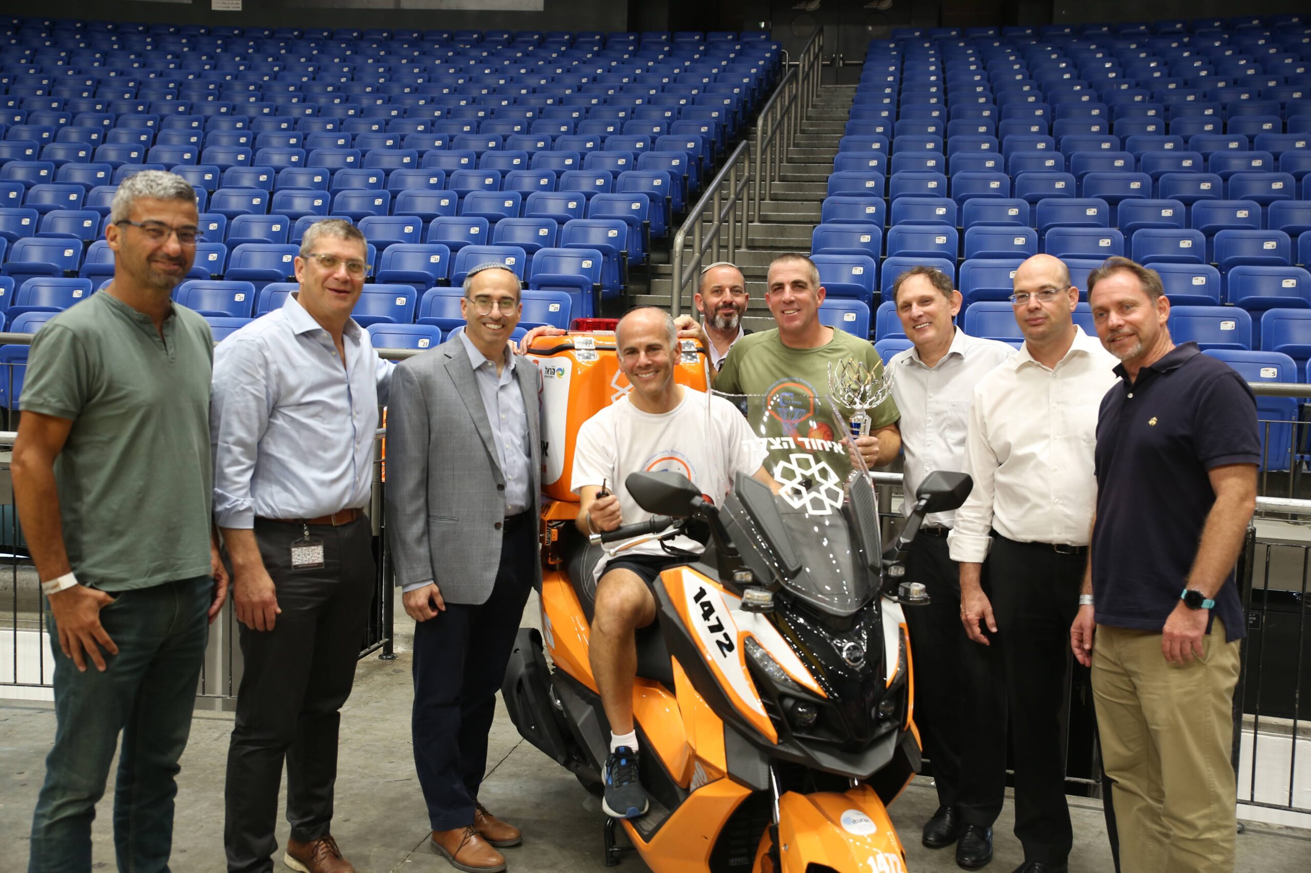 Jeremy Lustman Center and heads of the other law firms pose with the ambucycle that was donated scaled 1