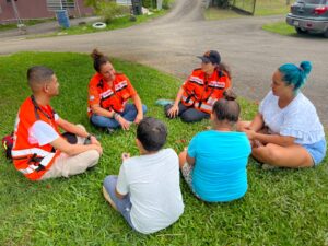 Members of the Psychotrauma and Crisis Response Team Tamar Schlezinger Gabriel Rourka and local medical student Luis Vasquez providing psychological first aid to a family in Anasco 300x225 1