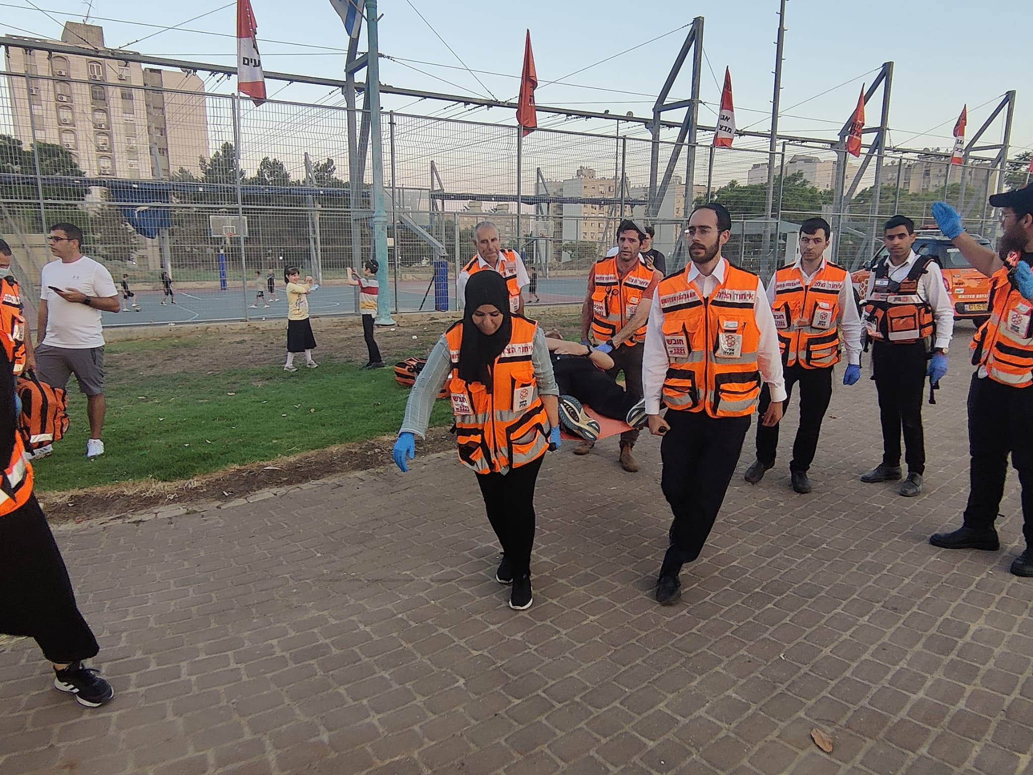 Muslim Jewish and Christian responders carry a patient with simulated injuries to a waiting ambulance 1