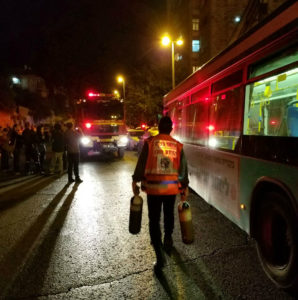 Psychotrauma EMT carrying oxygen to give to those in need during apartment fire