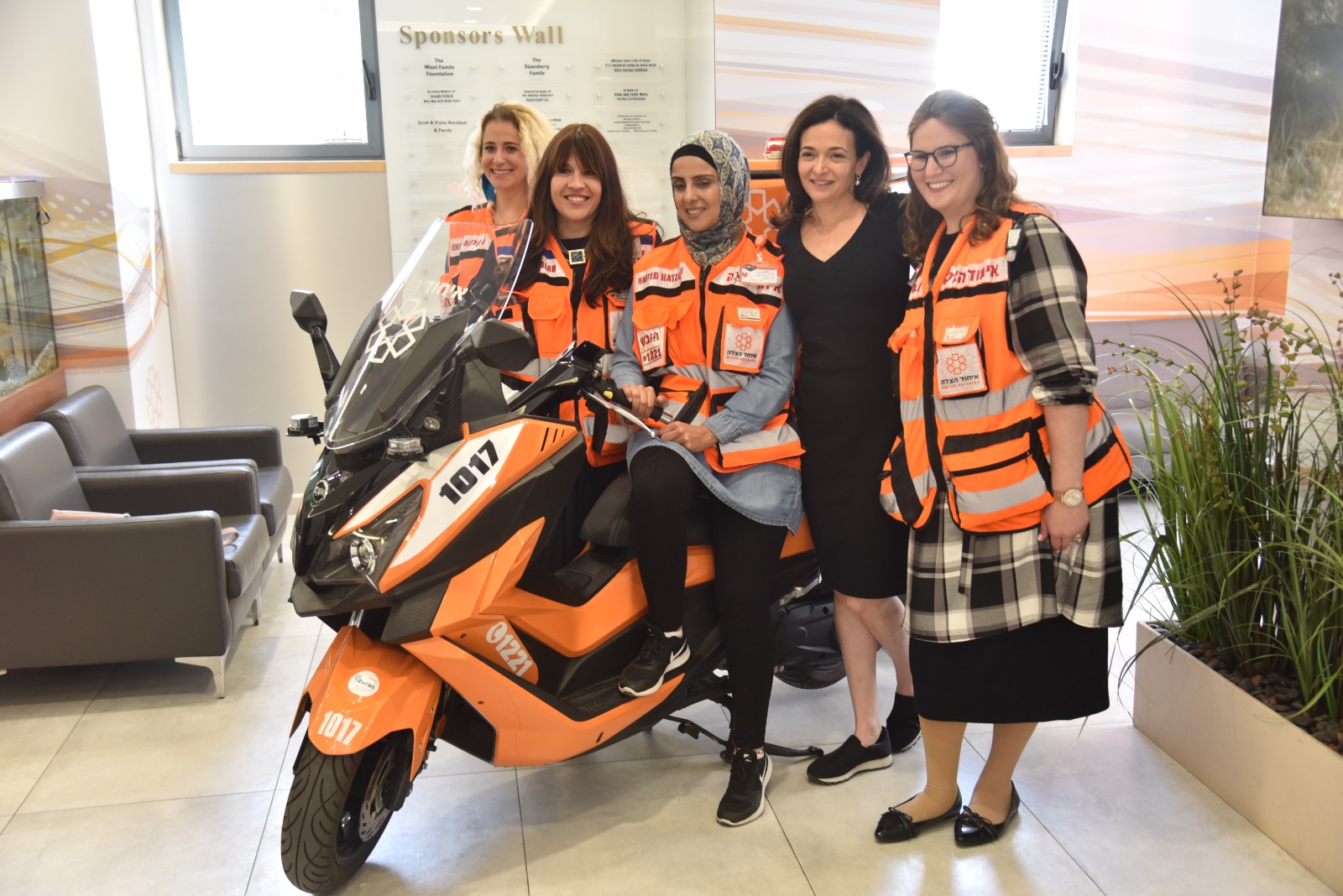 Sheryl Sandberg stands next to United Hatzalah women EMTs during a visit to the organizations headquarters in Jerusalem 2