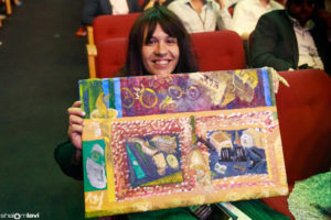Gittel Beer receives the painting by Lipa Schmeltzer