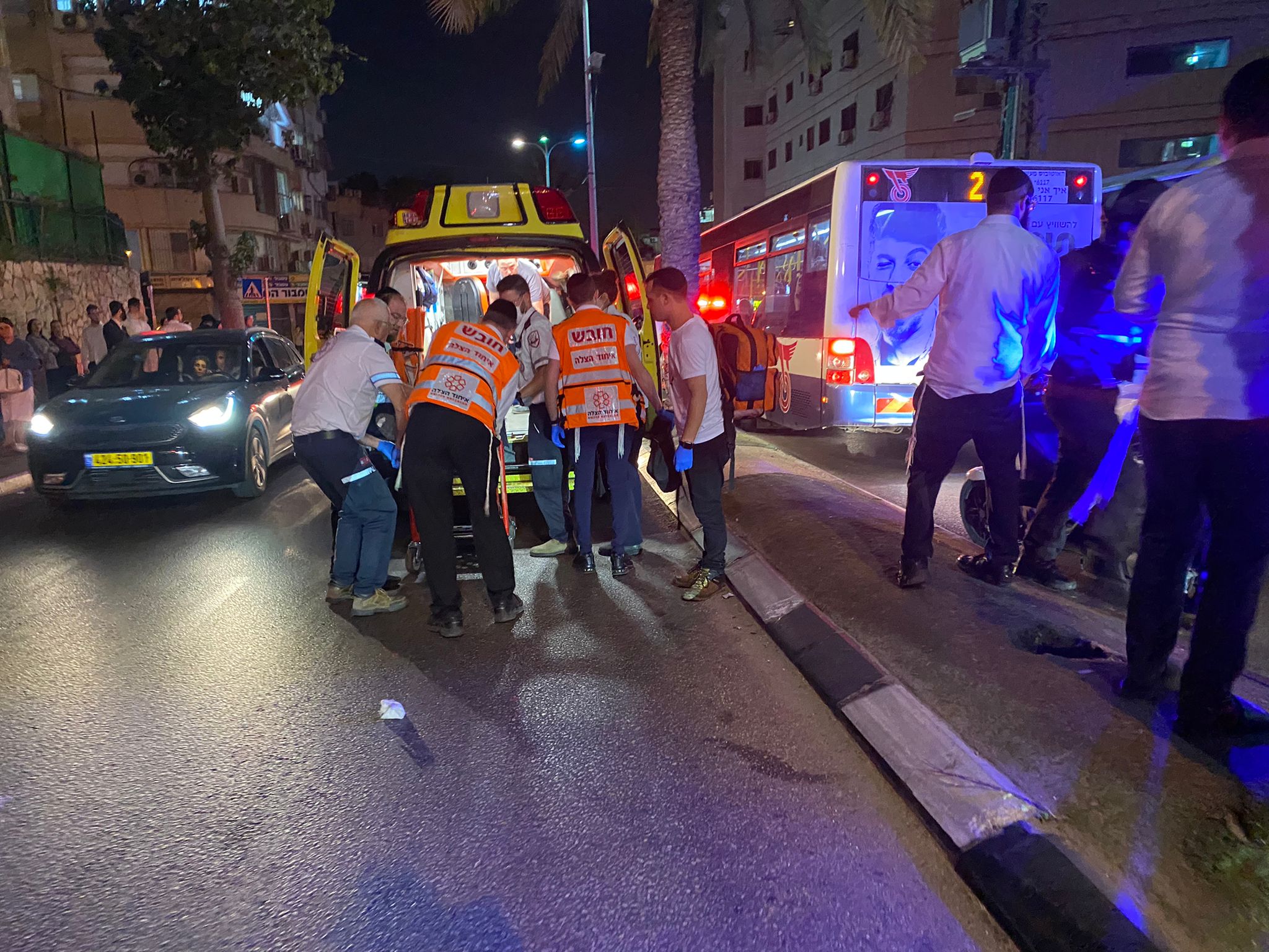 United Hatzalah volunteers help a patient into an ambulance in Gush Dan Illustration 1