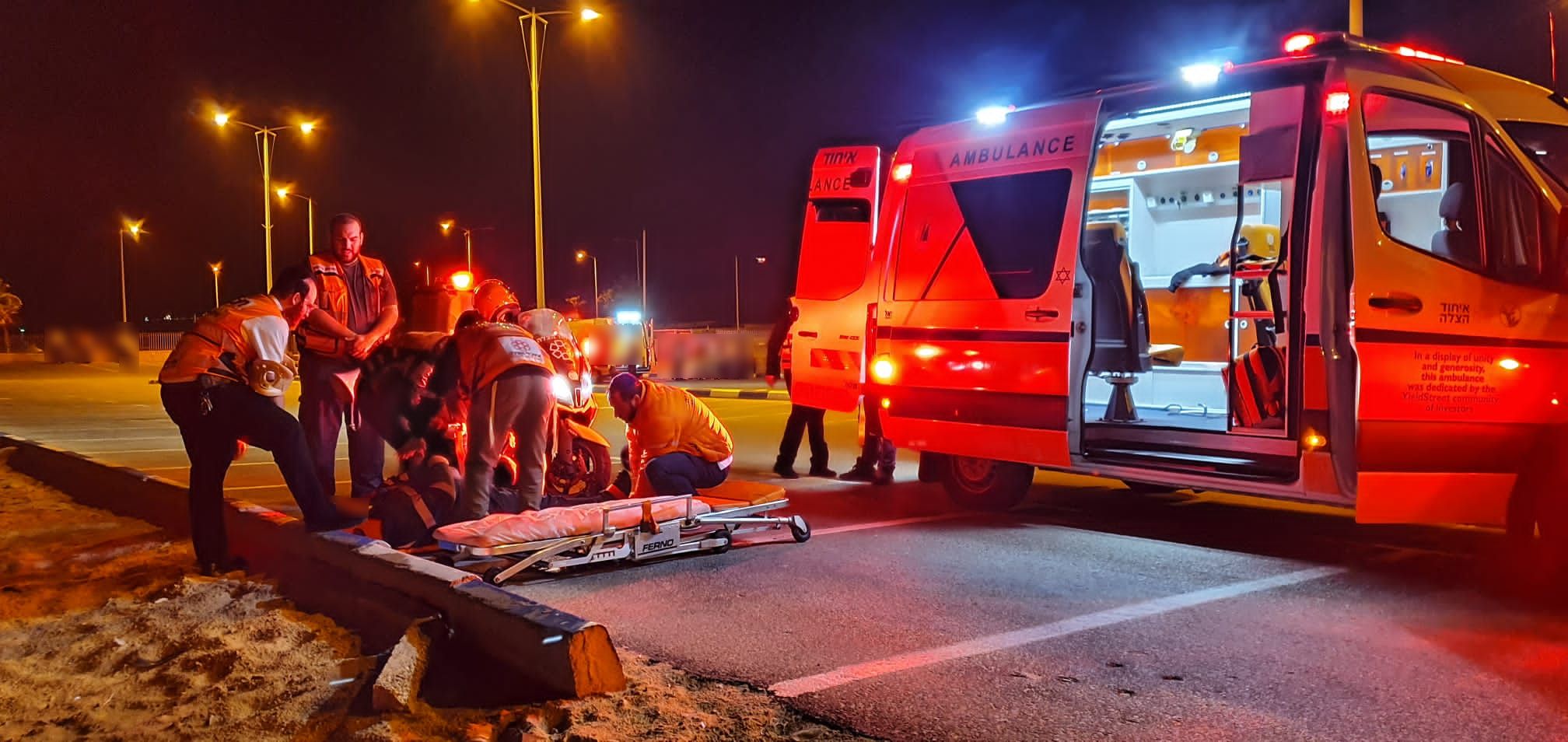 United Hatzalah volunteers treating a collapsed man at night Illustration 1