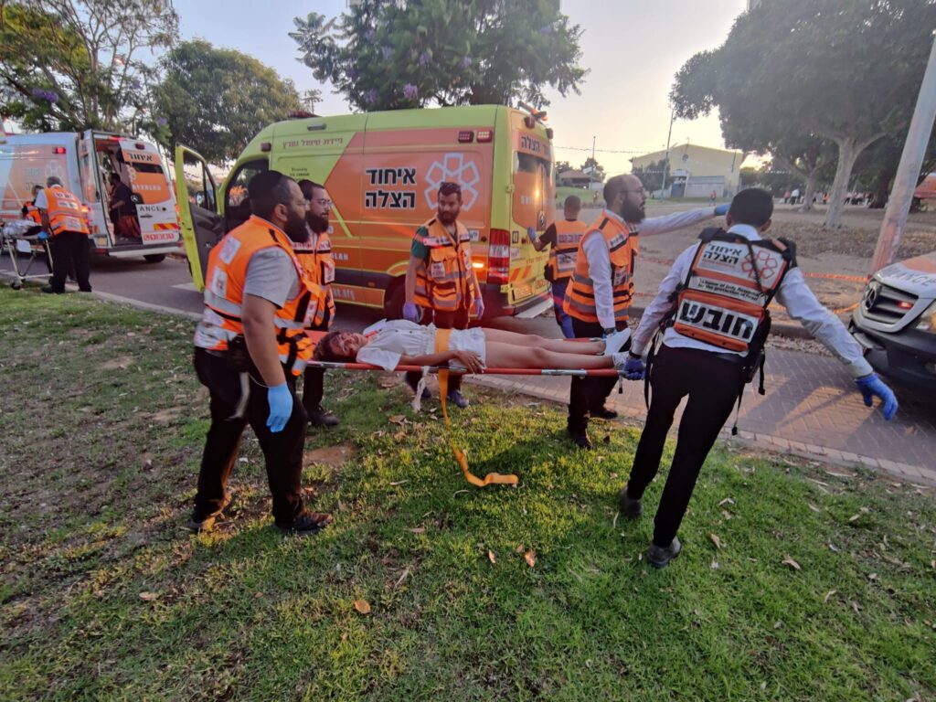 Volunteers carry a patient with simulated injuries to a waiting ambulance during the drill 1024x768 2