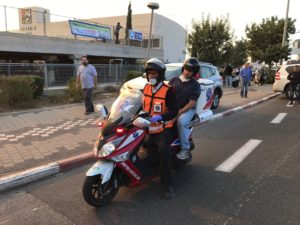 Education Minister Naftali Bennett assessed the situation in Haifa from the back of a United Ambucycle on Thursday