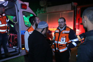 United Hatzalah EMS responders talk with Fire and Rescue responders on the night after the November fires in Haifa. Illustration - Credit: Shmulik Hershkopf - United Hatzalah
