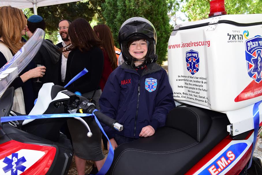 Max Balk in full United Hatzalah swag with the Motorcycle donated in his name. (Photo Credit: Koby Amsalem/United Hatzalah)