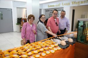 The Eisenmanns symbolically cutting the ribbon on the dolls 1 1024x683 1