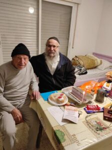 Mordechai Greenstein left and Yosef Azrad lighting Chanukah candles 766x1024 1