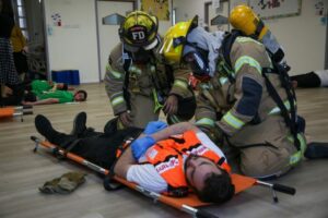 firefighters attend to a United Hatzalah volunteer who had a simulated injury during the drill 1024x683 1
